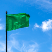 Green flag against a blue sky